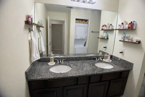 a bathroom with sink granite and a mirror