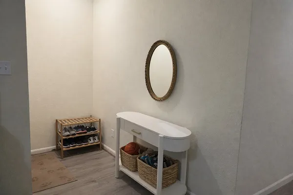 a room with a mirror and a wooden floor