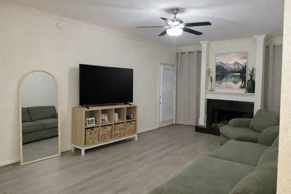 a living room with furniture and a flat screen tv