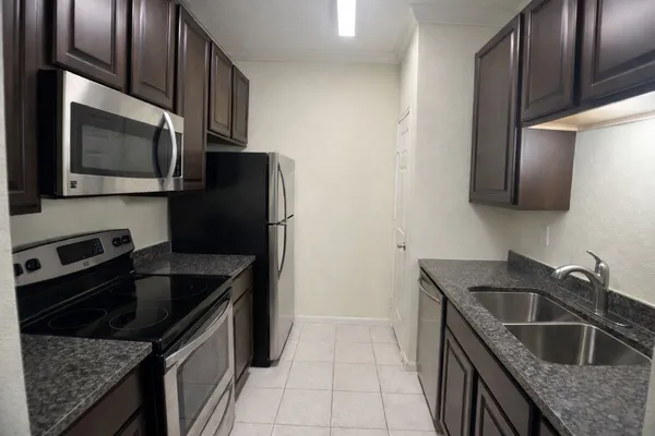 a kitchen that has a sink and a stove