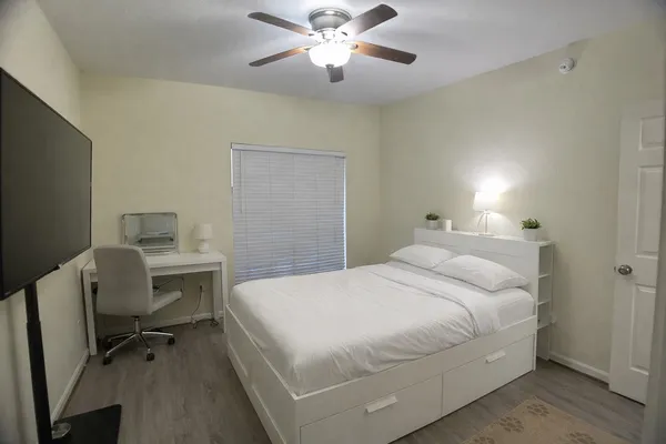 a bedroom with a bed and a desk