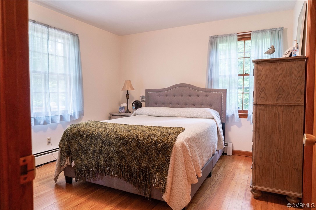 12808 South Chester Road Chester, VA 23831 - Photo 19 of 32 a bedroom with a bed and a refrigerator