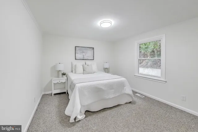 a bedroom with a bed and window