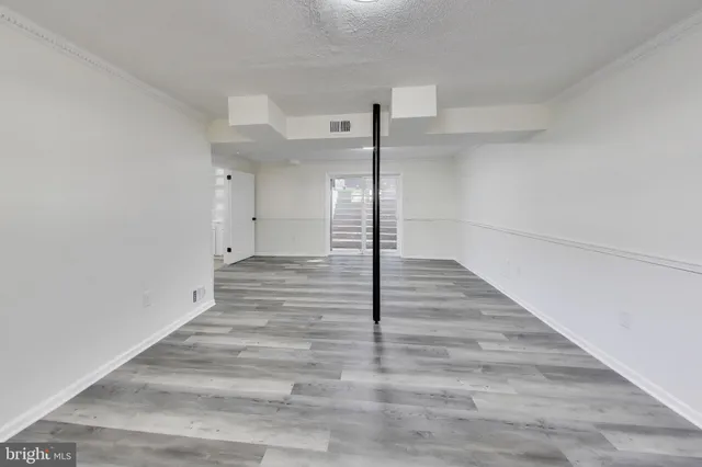 a view of a hallway view with wooden floor and staircase