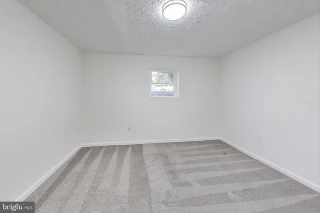 a view of a room with wooden floor and white walls