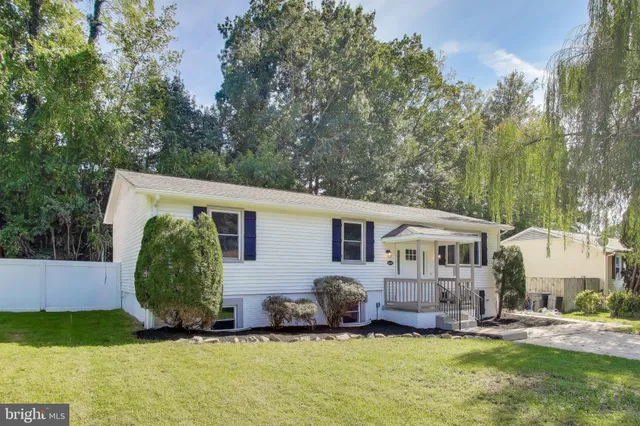 a view of a house with a yard and sitting area