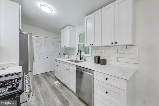 a kitchen with appliances cabinets and a sink