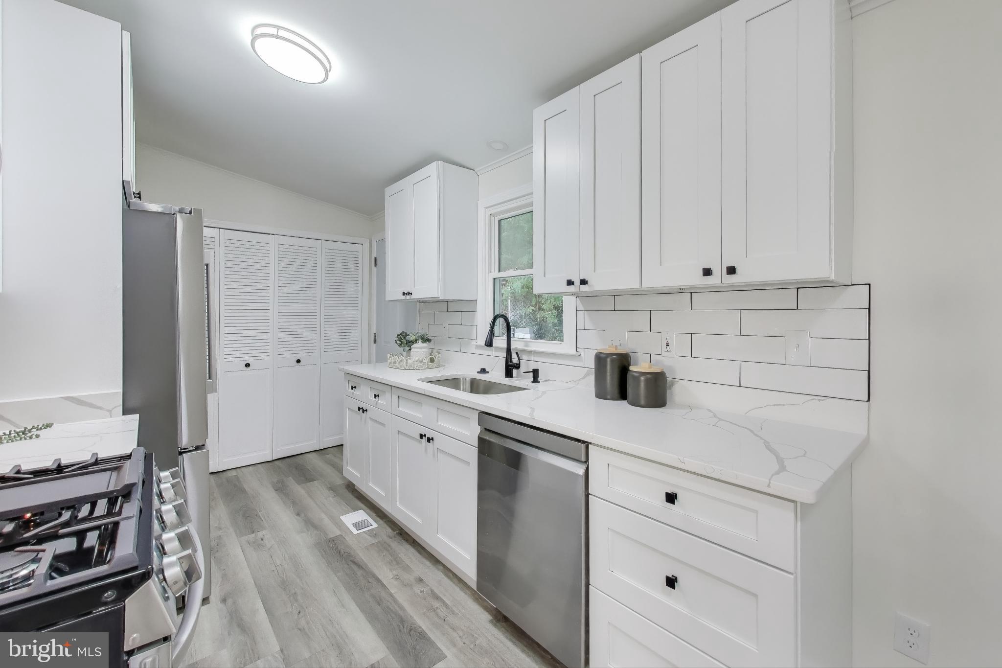 18905 Red Oak Lane Triangle, VA 22172 - Photo 9 of 38 a kitchen with appliances cabinets and a sink