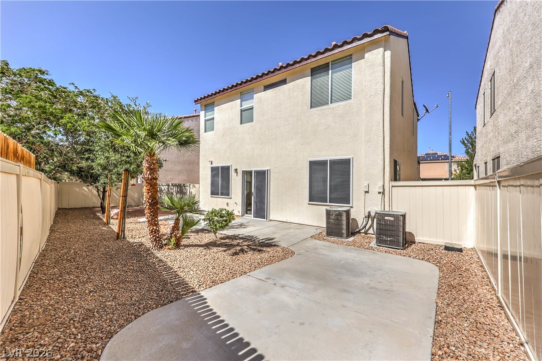 10939 Paradise Road Henderson, NV 89052 - Photo 36 of 36 Enjoy outdoor living with a spacious concrete patio and low-maintenance gravel landscaping.