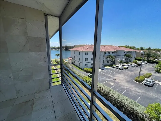 a city view from a balcony with chairs