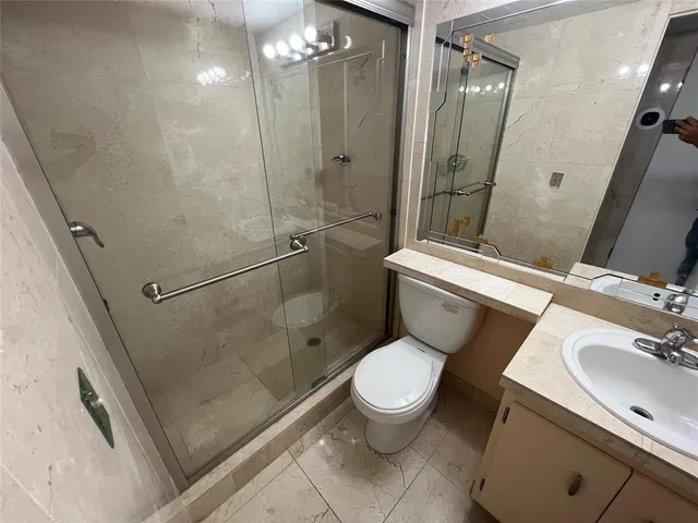 a white toilet sitting next to a bathroom sink