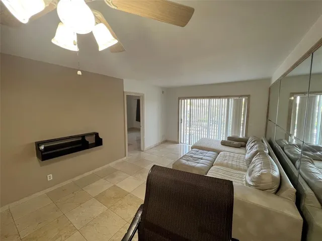 a bedroom with a bed a couch and a chandelier