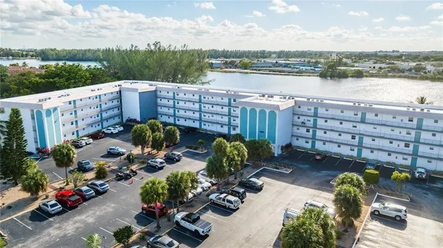 a view of a lake with a bench in front of house