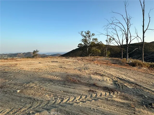 an aerial view of house with yard and mountain view in back