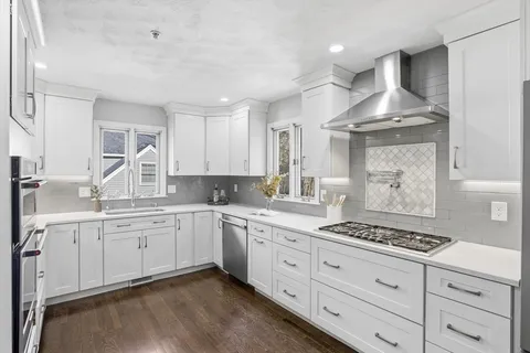 a kitchen with stainless steel appliances a sink stove and cabinets