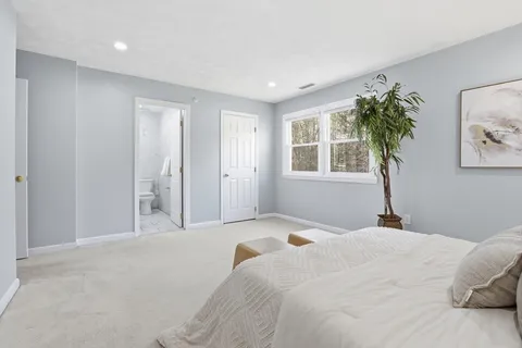 a bedroom with a large bed and a window