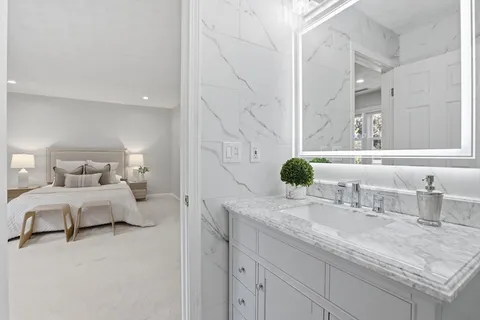 a bathroom with a granite countertop sink and a mirror