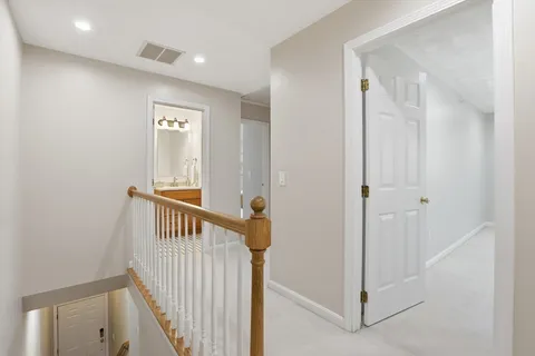 a view of a hallway with entryway door