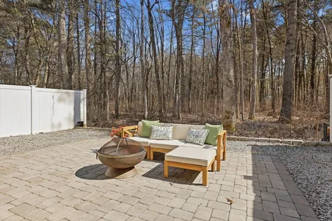 a backyard of a house with table and chairs