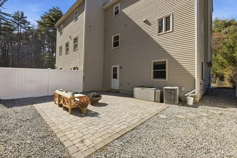 a backyard of a house with parked cars