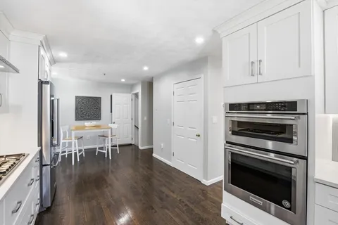 a kitchen with granite countertop a stove and a refrigerator