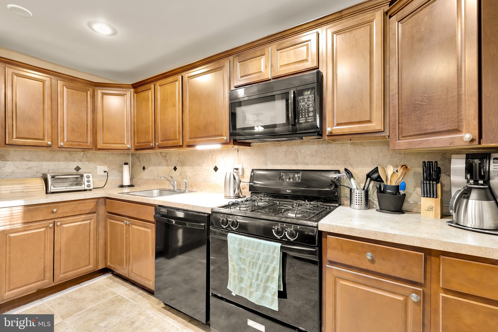 3313 Claridge Court Silver Spring, MD 20902 - Photo 15 of 23 a kitchen with stainless steel appliances granite countertop a sink a stove and cabinets