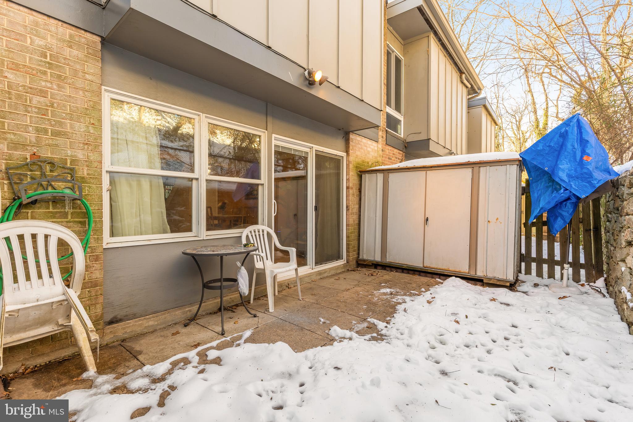 3313 Claridge Court Silver Spring, MD 20902 - Photo 23 of 23 a view of a house with a wooden bench in a backyard