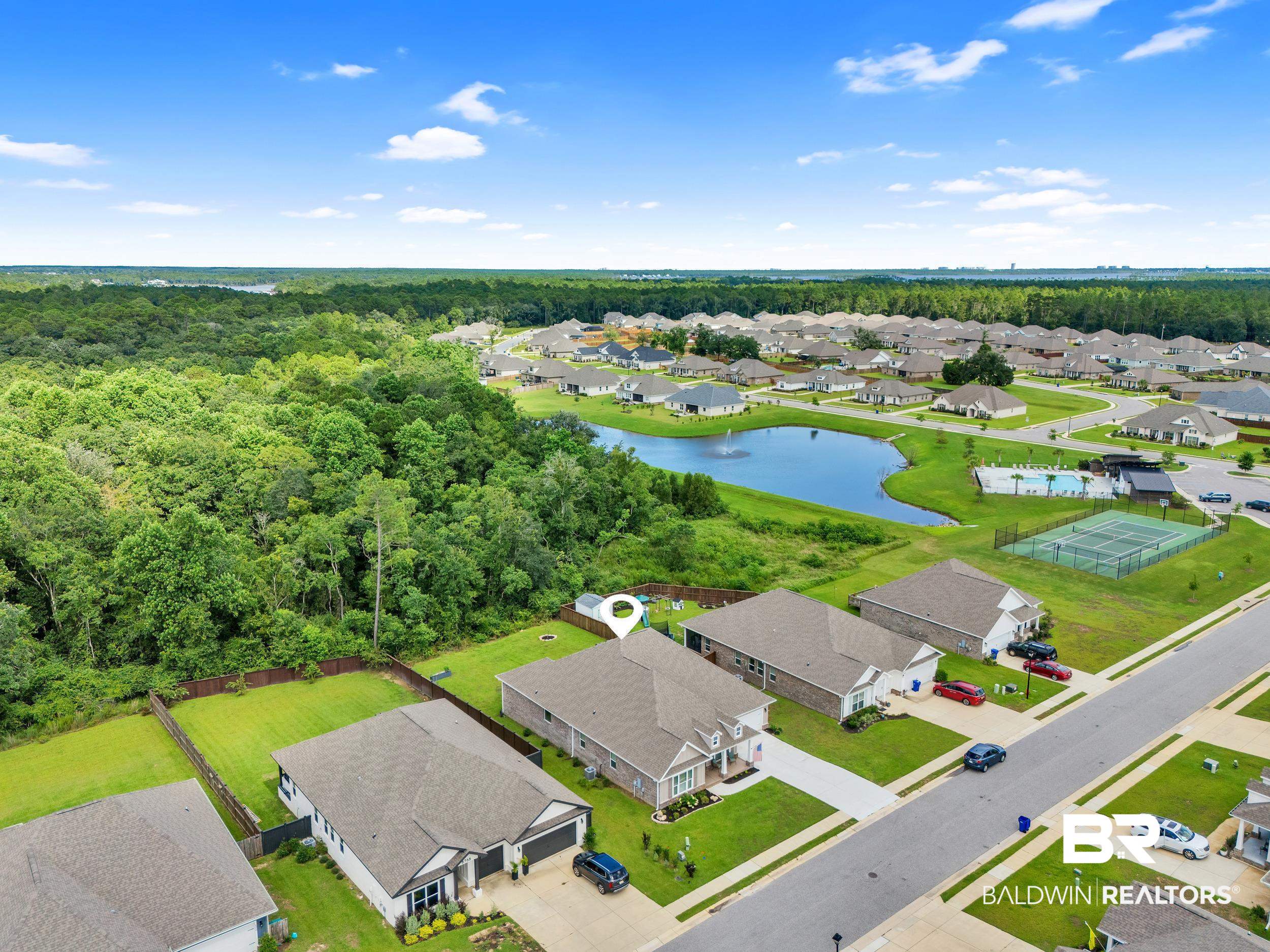 8774 Primland Boulevard Foley, AL 36535 - Photo 45 of 49 Aerial view of residential area with a large body of water and a heavily wooded area