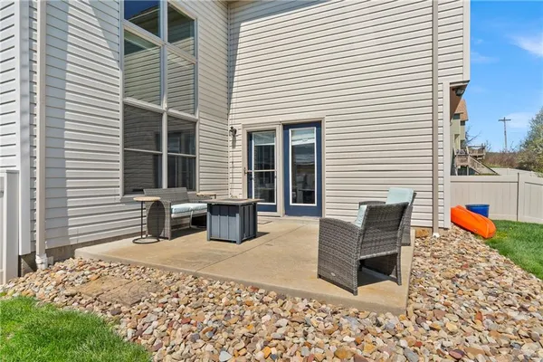 a backyard of a house with barbeque oven table and chairs