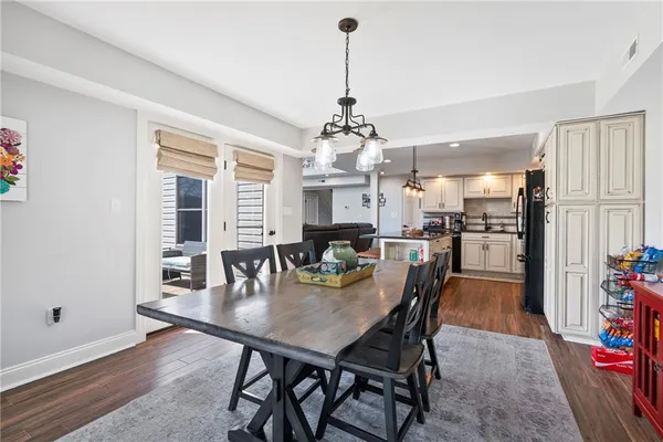 a dining room with furniture window and wooden floor