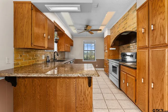 a view of an empty room with window and chandelier