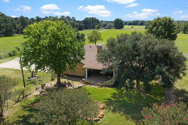 a view of a garden with a building in the background