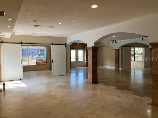 a view of a hallway with entryway wooden floor and front door