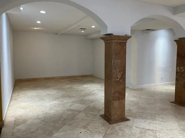 a view of a hallway with stainless steel appliances