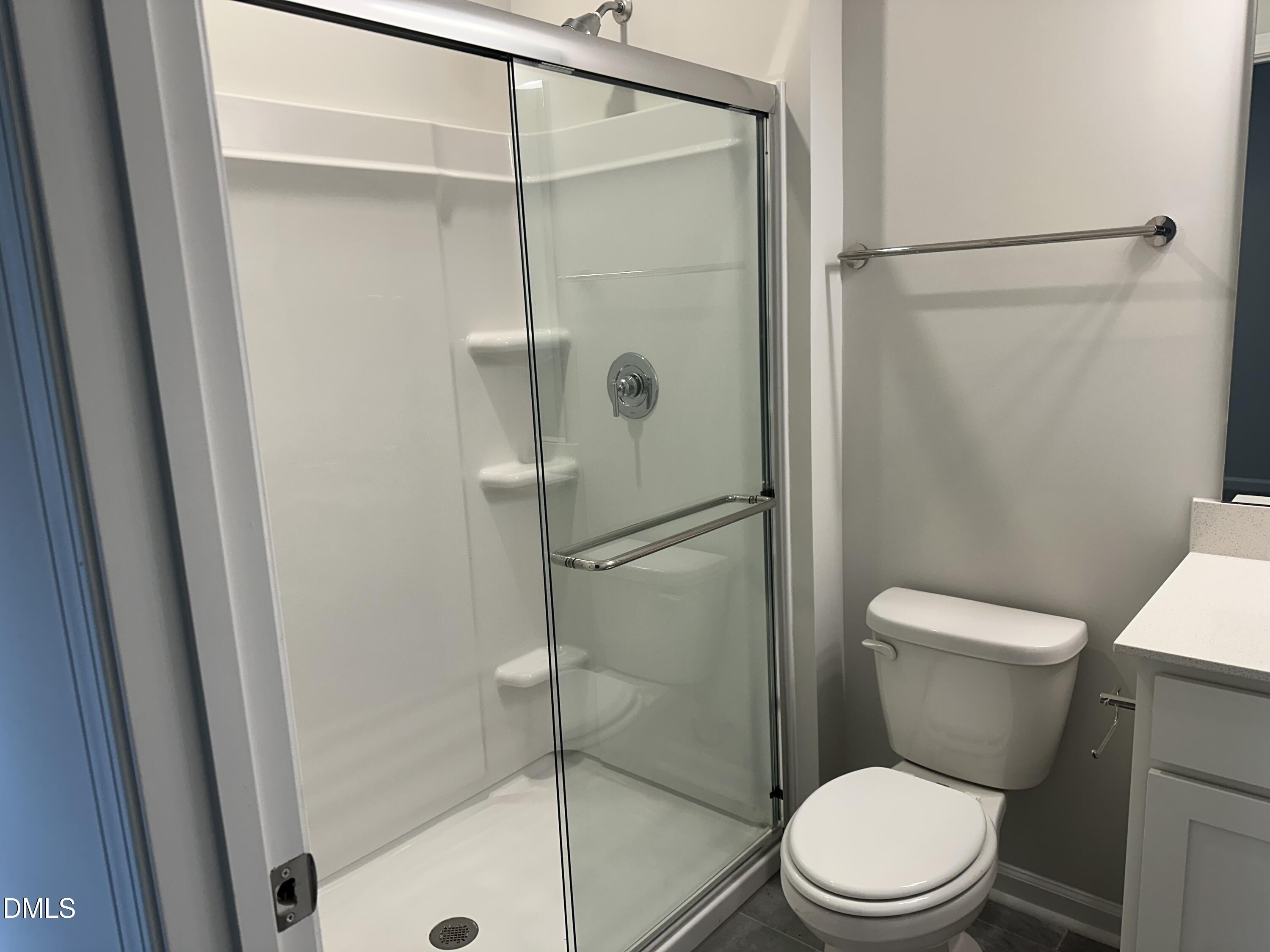 2540 Olive Chapel Road Apex, NC 27502 - Photo 15 of 27 a white toilet sitting next to a bath tub