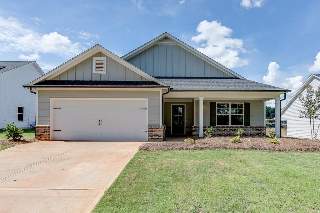 2924 Manley Street Carnesville, GA 30521 - Photo 1 of 1 a front view of a house with a yard and porch