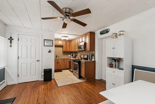 a kitchen with cabinets and wooden floor