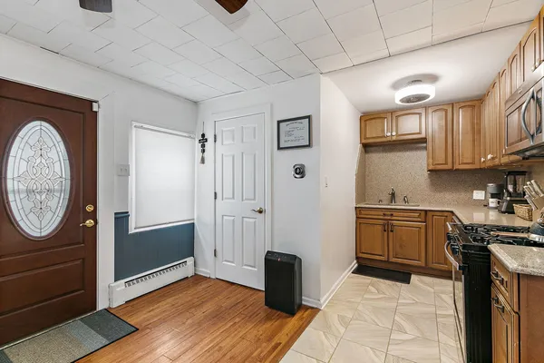 a kitchen with a refrigerator and a stove top oven