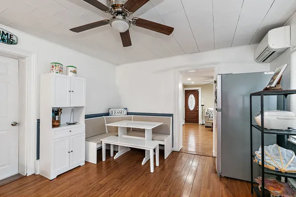 a view of a workspace with furniture and wooden floor