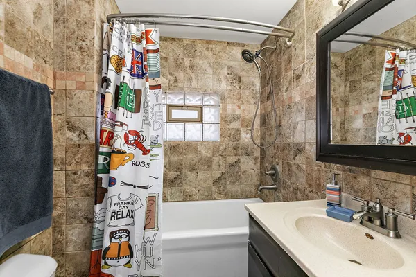 a bathroom with a sink toilet and shower