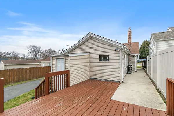 a view of a house with wooden deck