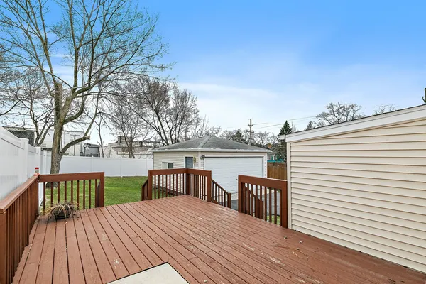 a view of a roof deck with wooden floor and fence
