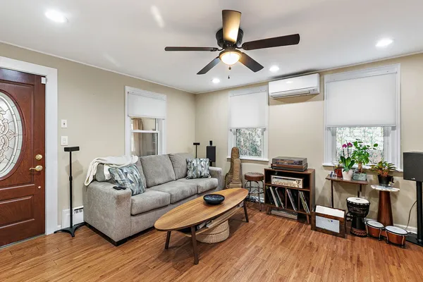 a living room with furniture and a wooden floor