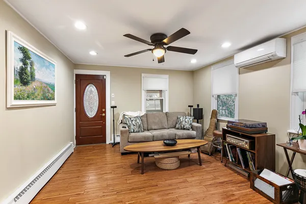 a living room with furniture a window and a piano