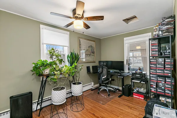 a living room filled with furniture and a potted plant