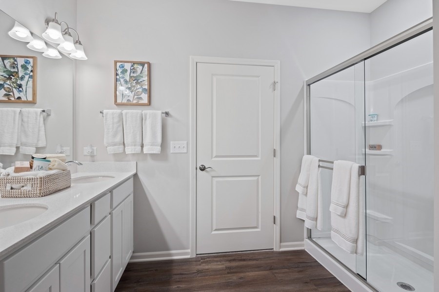 25612 West Springview Drive Plainfield, IL 60586 - Photo 14 of 23 a bathroom with a double vanity sink mirror and shower