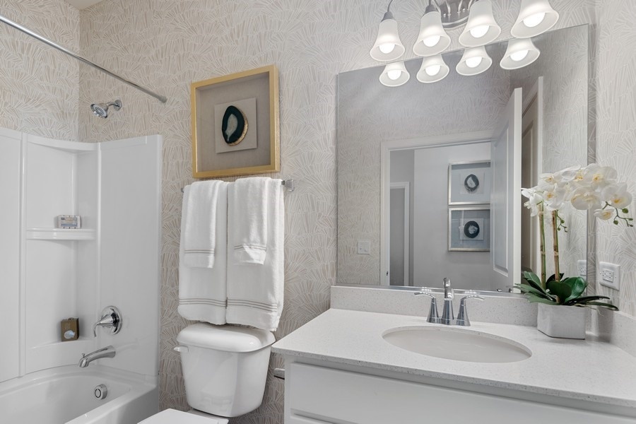 25612 West Springview Drive Plainfield, IL 60586 - Photo 15 of 23 a bathroom with a toilet a sink and a bathtub