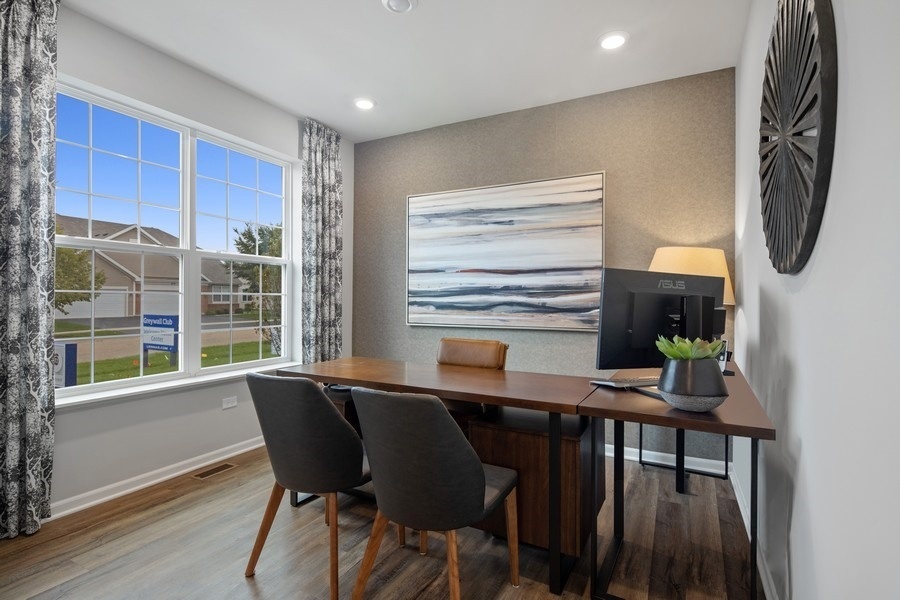 25612 West Springview Drive Plainfield, IL 60586 - Photo 2 of 23 a view of a dining room with furniture window and wooden floor