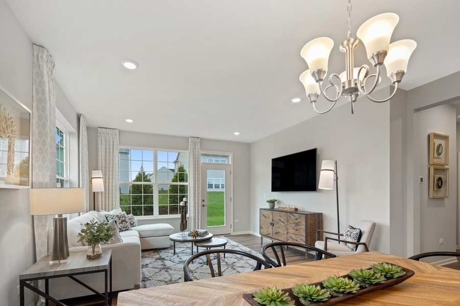 25612 West Springview Drive Plainfield, IL 60586 - Photo 6 of 23 a living room with furniture chandelier and a flat screen tv