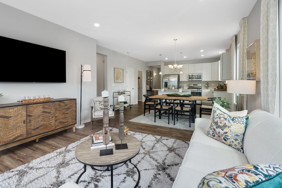 25612 West Springview Drive Plainfield, IL 60586 - Photo 9 of 23 a living room with furniture and a flat screen tv